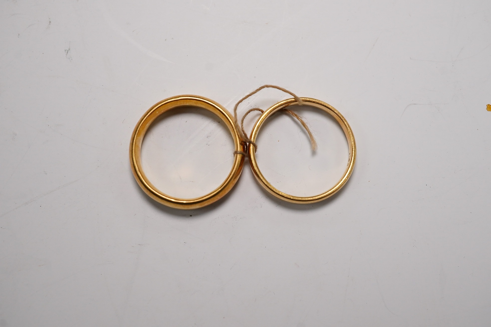 Two 22ct gold wedding bands, K/L & L, 10.3 grams. Condition - fair
